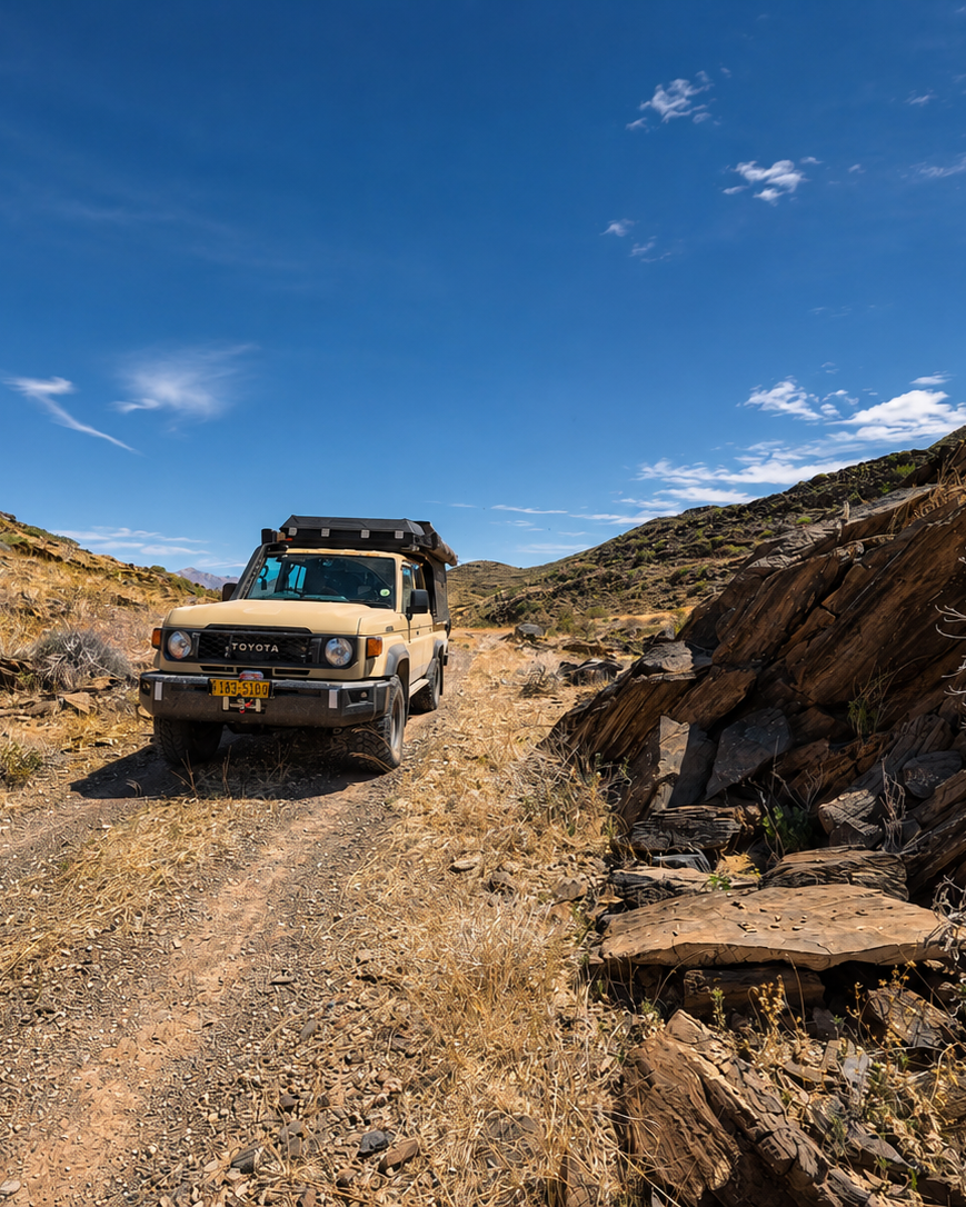 4x4 vehicle driving on a rocky mountain road