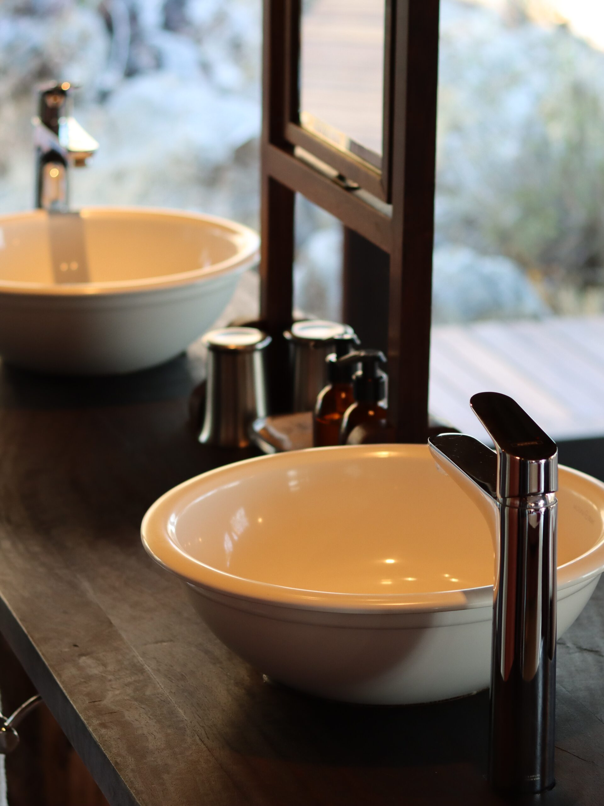 Lodge bathroom basins, fittings and reflected interior detail