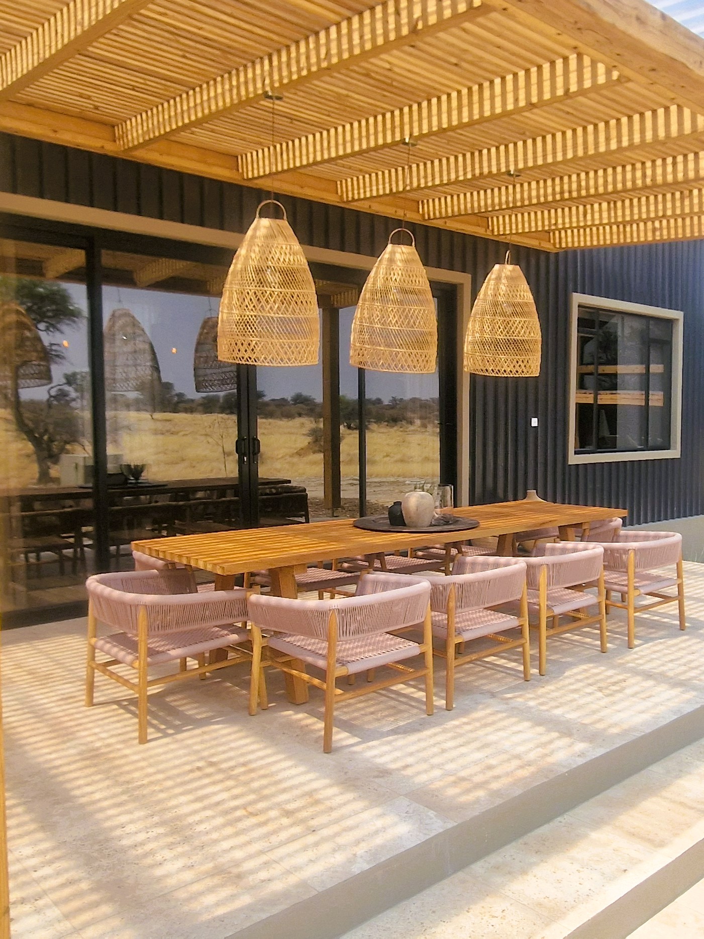 Contemporary lodge exterior with shaded dining terrace