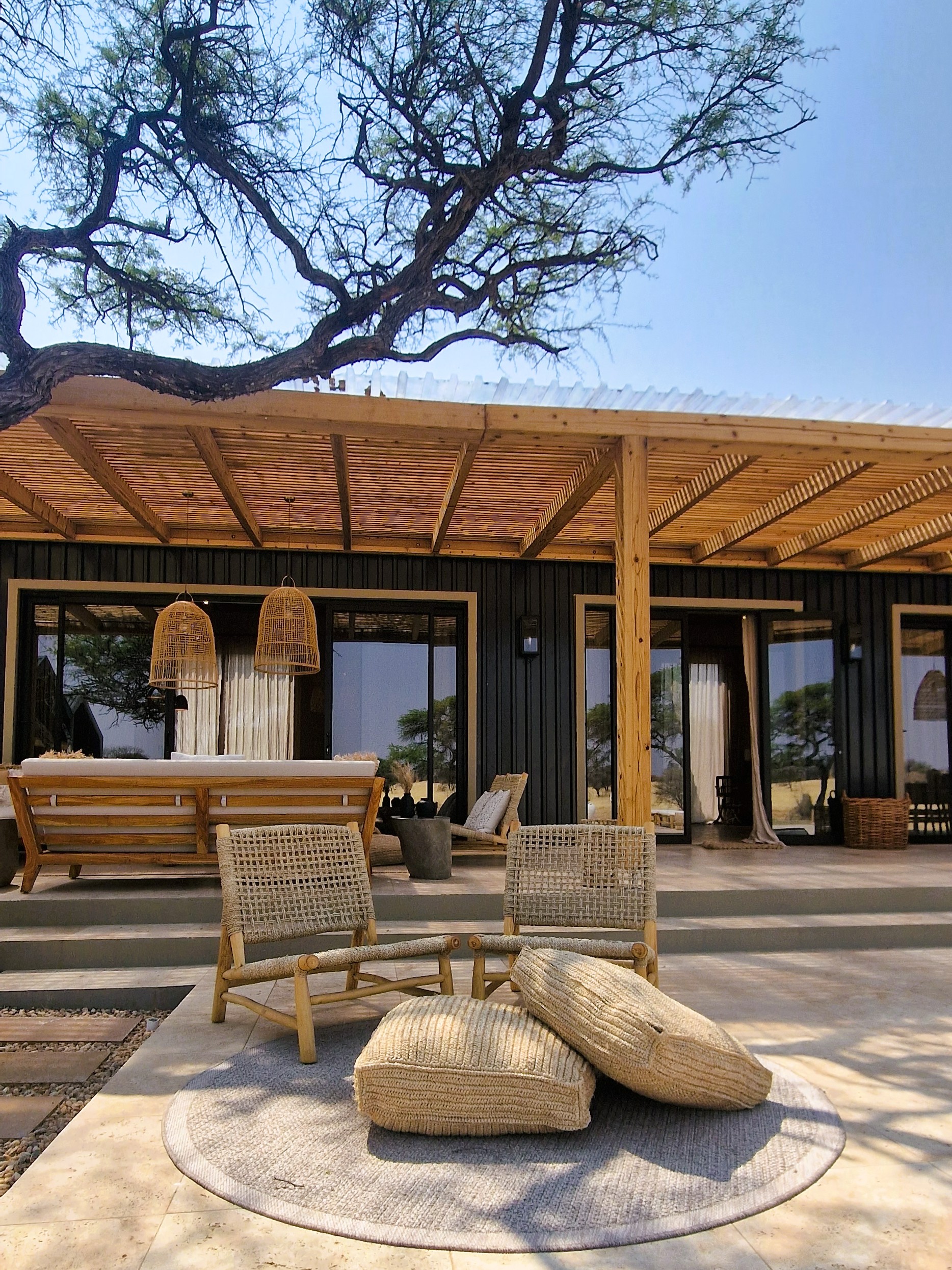 Lodge architecture, outdoor seating and natural landscape setting